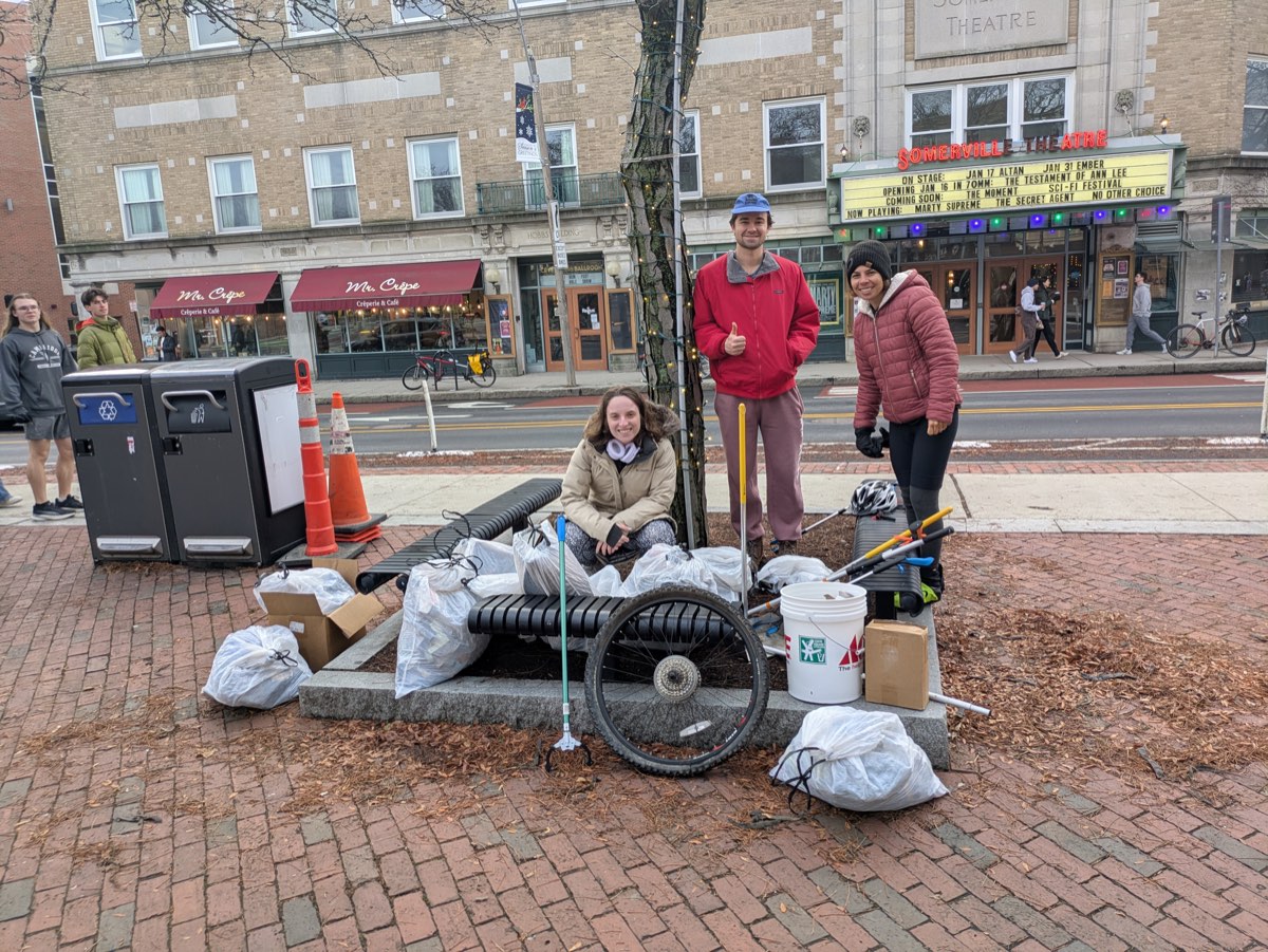 Litter crew volunteers with bags of collected trash in Davis Square, winter